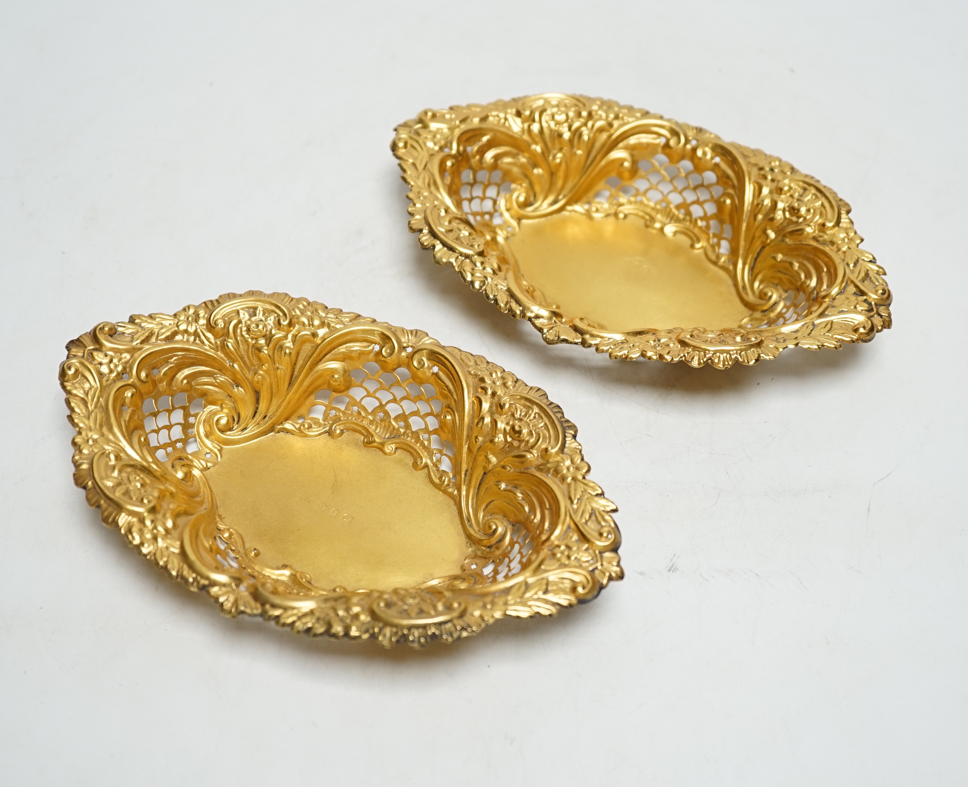A pair of late Victorian matt finish pierced repousse silver gilt oval dishes, Birmingham, 1897, 18.2cm, 3.5oz